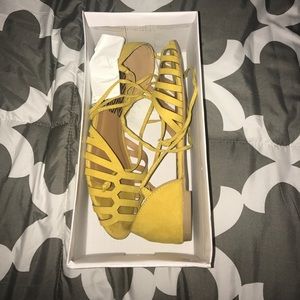 Quips yellow flats that strap around the ankle